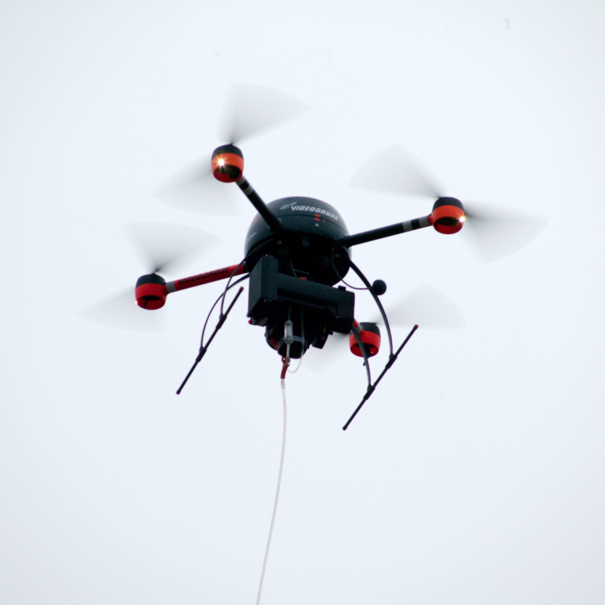 A drone with a BH-12 device hovering in the air.