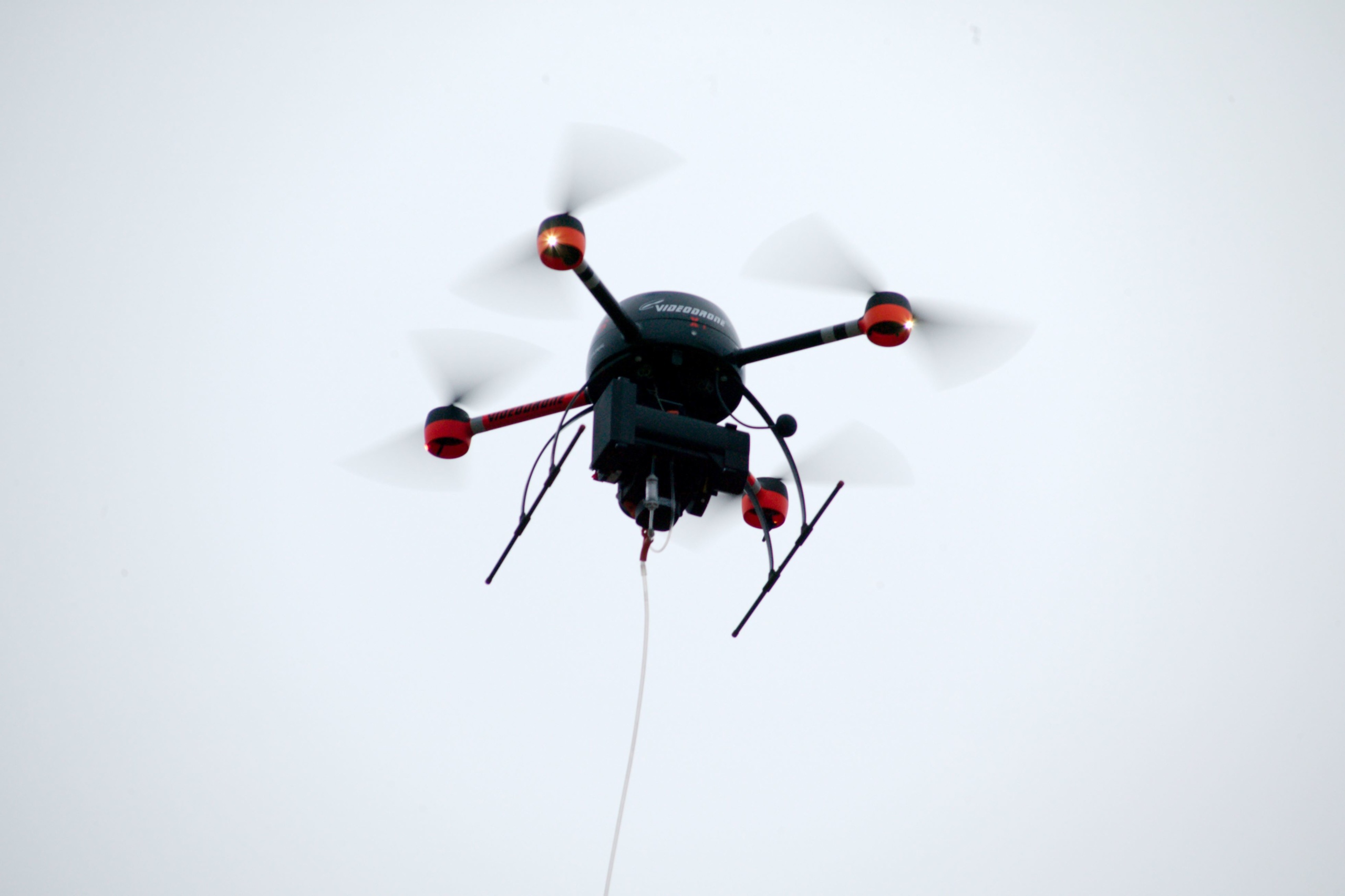 A drone with a BH-12 device hovering in the air.