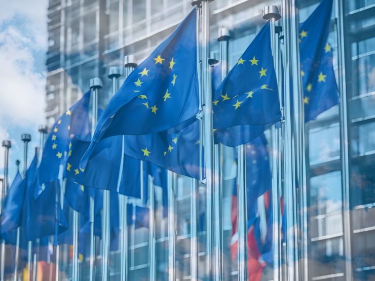 European Union flags flying over cloudy sky